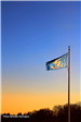 North Dakota flag in front of a sunset. 