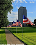 A row of American flags placed in front of North Dakota's State Capitol Building. 