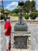 A boy looking at a statue. 