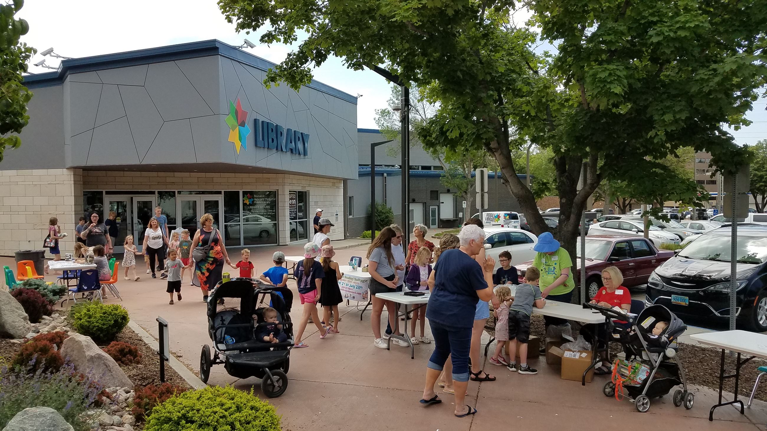 Bismarck Veterans Memorial Public Library summer event on outdoor plaza.