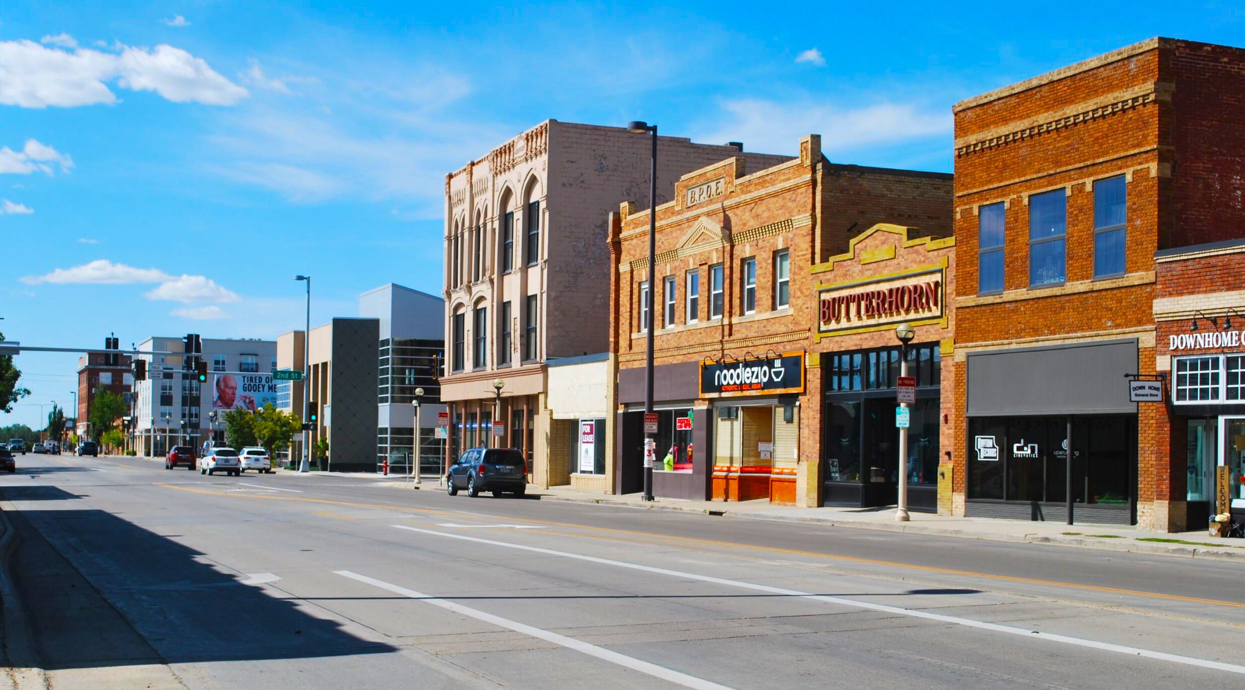 A number of business fronts are shown along a black of west Main Avenue in Bismarck.